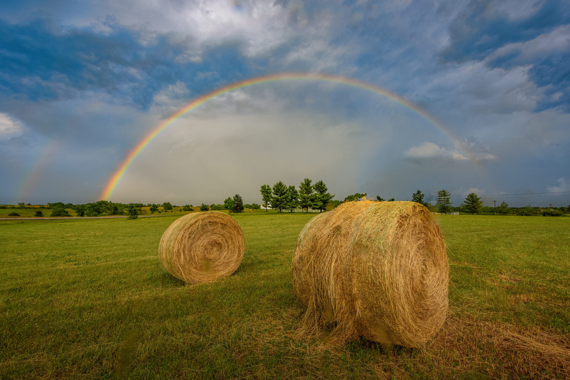 Rainbow over Iowa hay bales